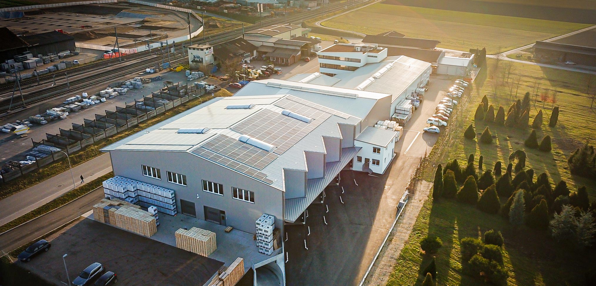 Aerial view of an industrial facility with solar panels.